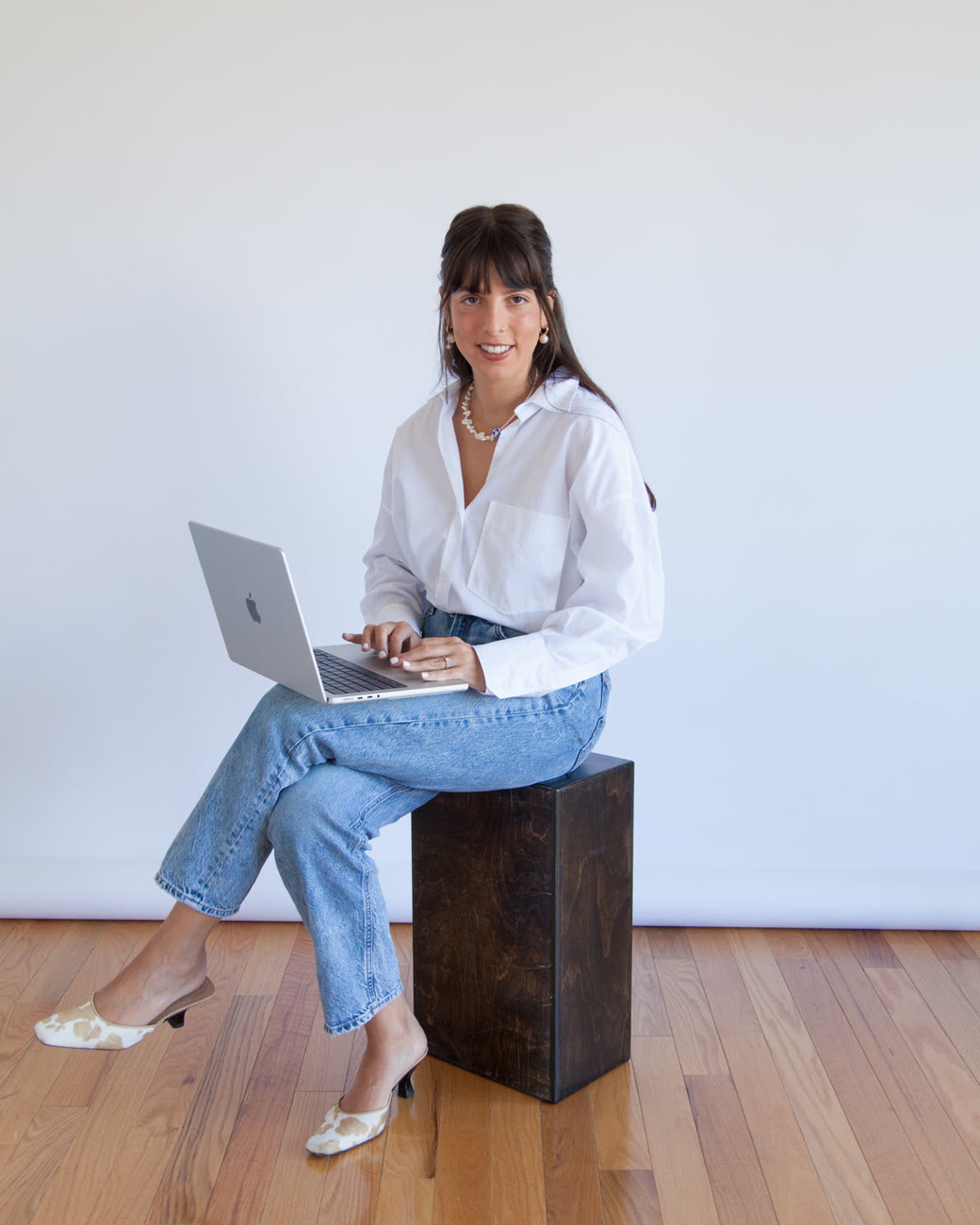 The founder of Alun Creative at a laptop